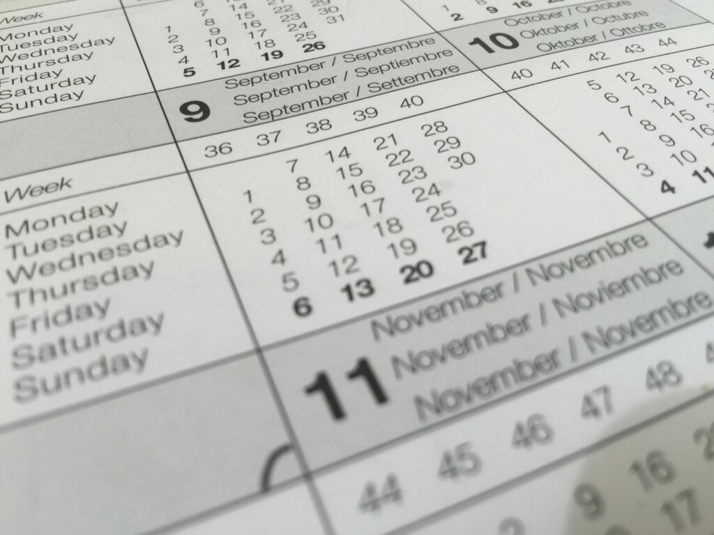 Detailed close-up of a calendar displaying months in several languages.